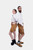 The couple standing back-to-back in their Neuschwanstein Couple Outfits. The woman wears a white blouse with golden-brown leather shorts that feature detailed embroidery, and black lace-up boots. The man is in a matching white button-down shirt and golden