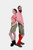 A couple standing back-to-back in their traditional Volksfest outfits. The woman wears a red checkered off-shoulder top and embroidered green leather shorts with black lace-up boots. The man is in a matching red checkered shirt and green leather shorts wi