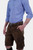 Side view of a man wearing traditional brown leather cargo Lederhosen paired with a blue striped shirt. The image highlights the side pockets and the belt buckle.