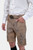 Close-up of the man's torso, highlighting the detailed embroidery on the beige Lederhosen and the ornate belt buckle. His white shirt is neatly tucked in.