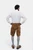 Rear view of a man wearing a white dress shirt and tan leather lederhosen shorts, showing the back pockets and overall fit of the lederhosen along with grey knee-high socks.