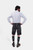 back view of a bearded man standing confidently in Black Forest Lederhosen, complete with knee-high socks and traditional shoes.
