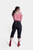 Back view of a woman in red and white checkered blouse and black Midnight Raven Lederhosen, emphasizing the detailed embroidery on the back.