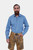 A man wearing the Edelweiss Lederhosen in Caramel Desert color, paired with a green checkered shirt, standing with a confident pose.