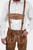 Man in Freud Lederhosen with white dress shirt and black bow tie, close-up on chest and lederhosen front.
