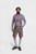 Man standing in Raphael Lederhosen with checkered dress shirt, brown shoes, and gray knee-high socks, full body shot.
