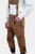 Side view close-up of Tegernsee Bundhosen trousers with suspenders. The image highlights the intricate embroidery and pocket details of the brown leather trousers.