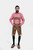 Full-body view of a man wearing Chiemsee Lederhosen with suspenders and a pink checkered shirt, standing with hands in pockets.