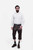 A man with a beard is wearing a white button-down shirt paired with Monte Carlo Bundhosen. The Bundhosen, made of dark brown leather, feature intricate embroidery and a decorative belt buckle. Paring with traditional socks and brown shoes.kniebund lederhose schwarz​