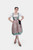 Full-length view of a woman wearing Dirndl Nilam, standing confidently in a mint and pink floral dirndl, showcasing the full skirt and apron.