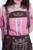 Close-up view of a woman wearing light brown knee-length lederhosen with natural-colored embroidery and decorative buttons, paired with a red and white checkered off-shoulder shirt.