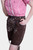 Side view of a woman showcasing light brown knee-length lederhosen with a lacing detail, paired with a red and white checkered off-shoulder shirt.