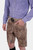 Another close-up of the DanubeLederhosen's side, focusing on the embroidery and button details, with the man's hand in the pocket.
