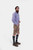 Full-body side view of the man in the blue checkered shirt and brown DanubeLederhosen, showcasing the outfit from a different angle.