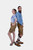 A side-by-side pose of a couple in the Adirondack Couple Outfit. The man and woman are dressed in matching blue and white gingham check tops and brown leather lederhosen with blue floral embroidery, highlighting the outfit's cohesive design.