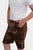A young boy wearing Sebastian Lederhosen in Cocoa Rust, showcasing intricate embroidery on the front flap, and standing with hands in pockets.