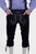The image shows a pair of traditional black leather Brandenburg Bundhosen Outfit with white embroidery, worn with a blue and white checkered shirt. The Bundhosen have intricate designs on the front and sides, and the person has their hands in the front pockets.