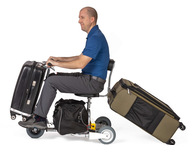 Traveler using a TravelScoot with luggage