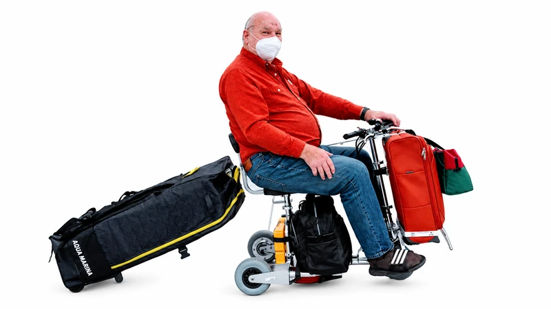TravelScoot rider carrying travel luggage against a white background