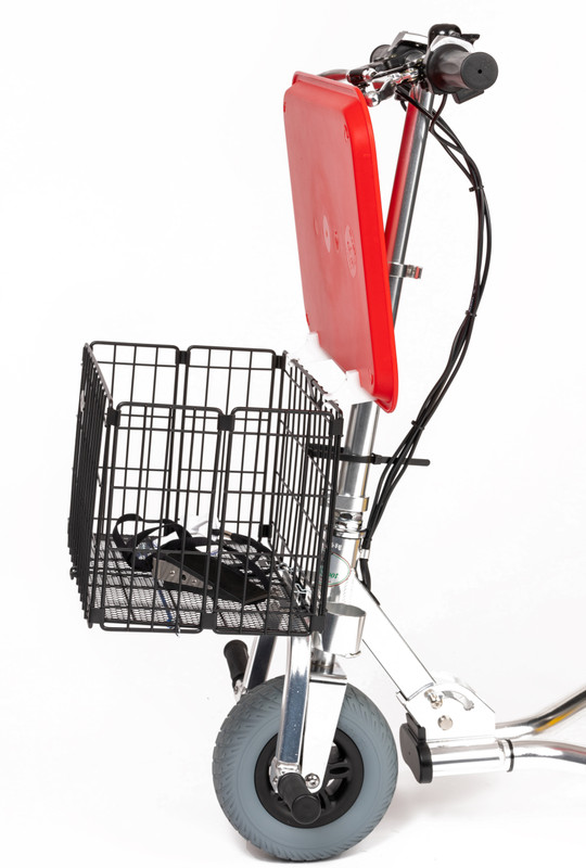 Side view of the black folding basket with the hinged cafeteria tray open and the lanyard, door stop, and suction cup inside.