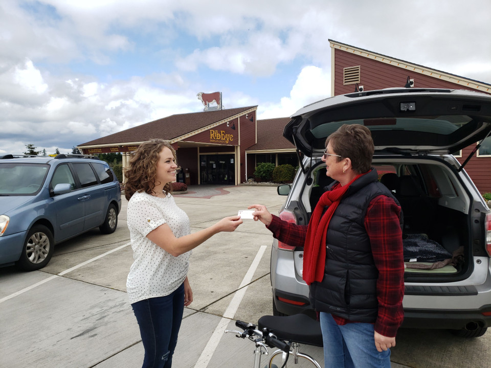 Woman sharing TravelScoot referral information with another woman