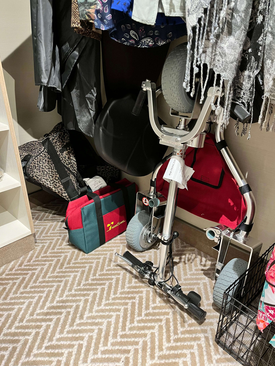 Compact TravelScoot stored in a cruise ship closet