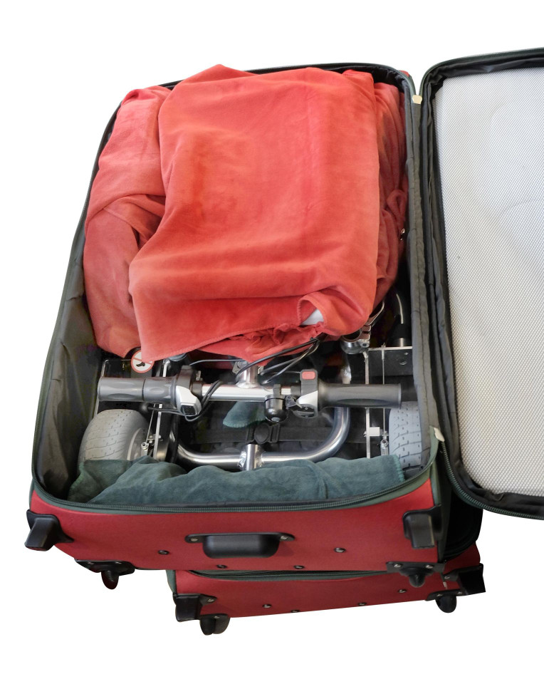 Close up of packed main luggage with scooter and towels.