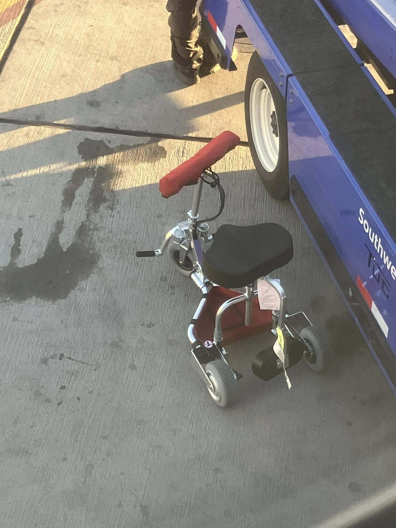 Travel scooter next to a Greyhound bus