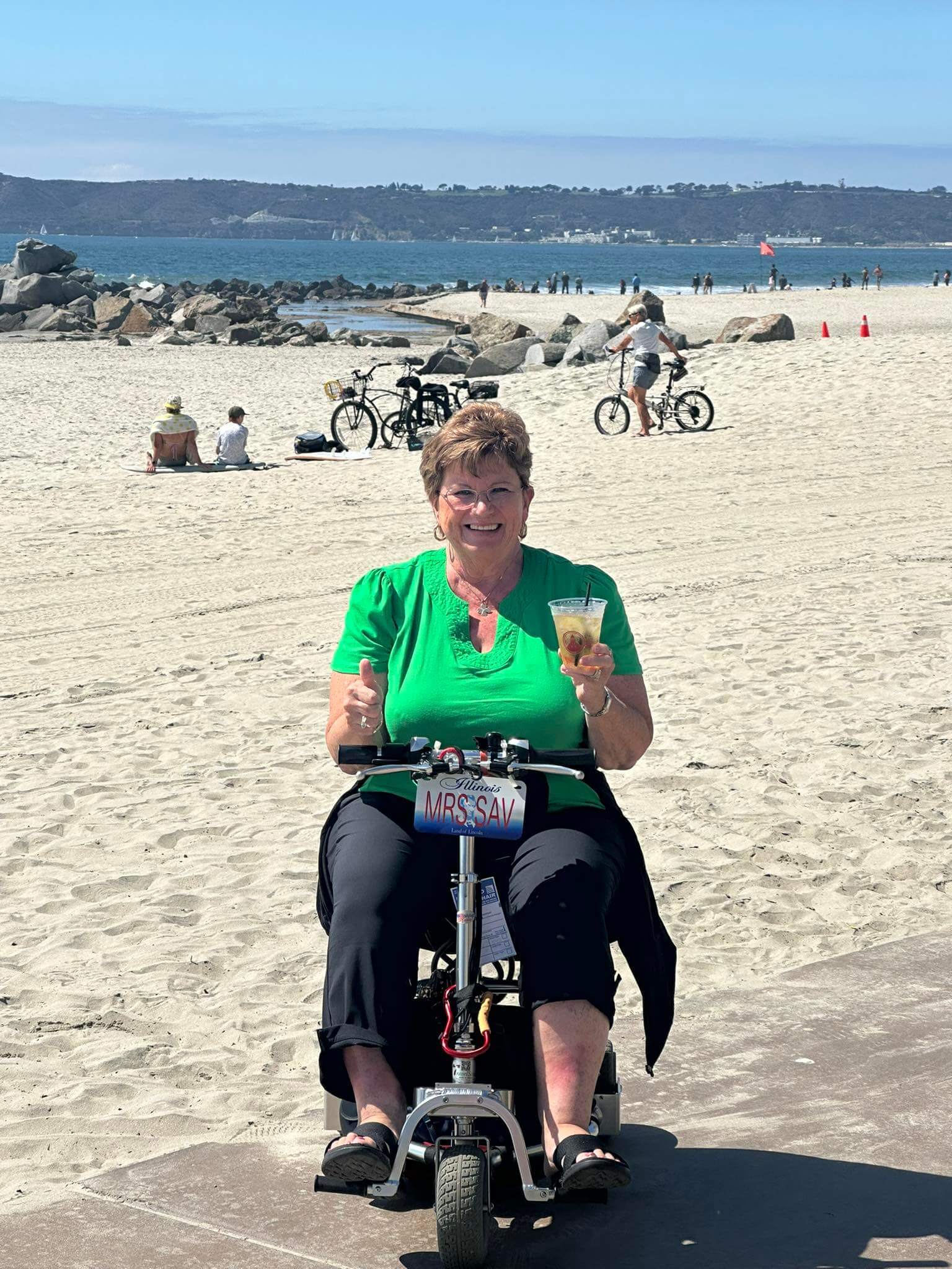 Woman on mobility scooter on the beach.