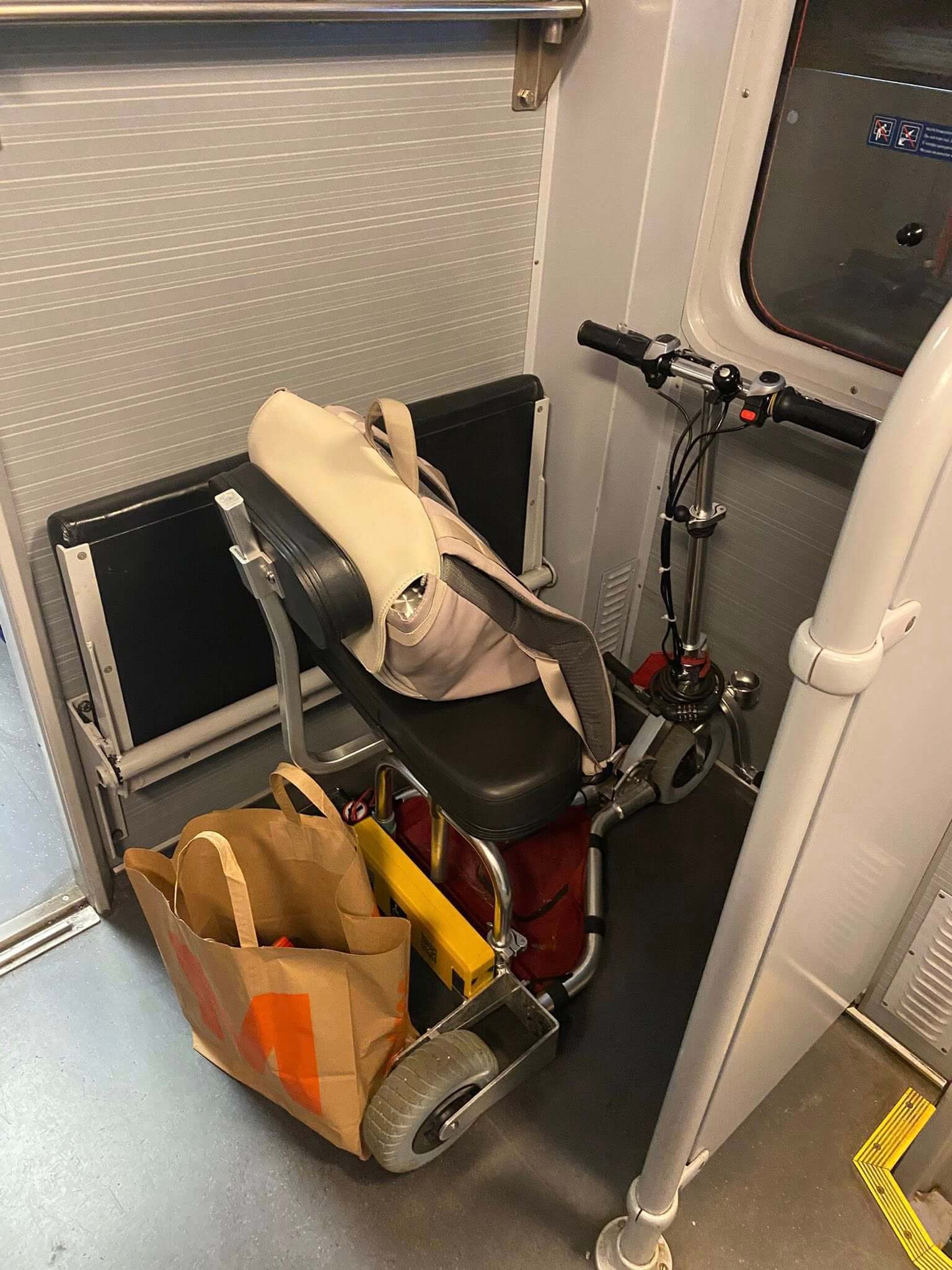 Lightweight mobility scooter in the corner of a train.