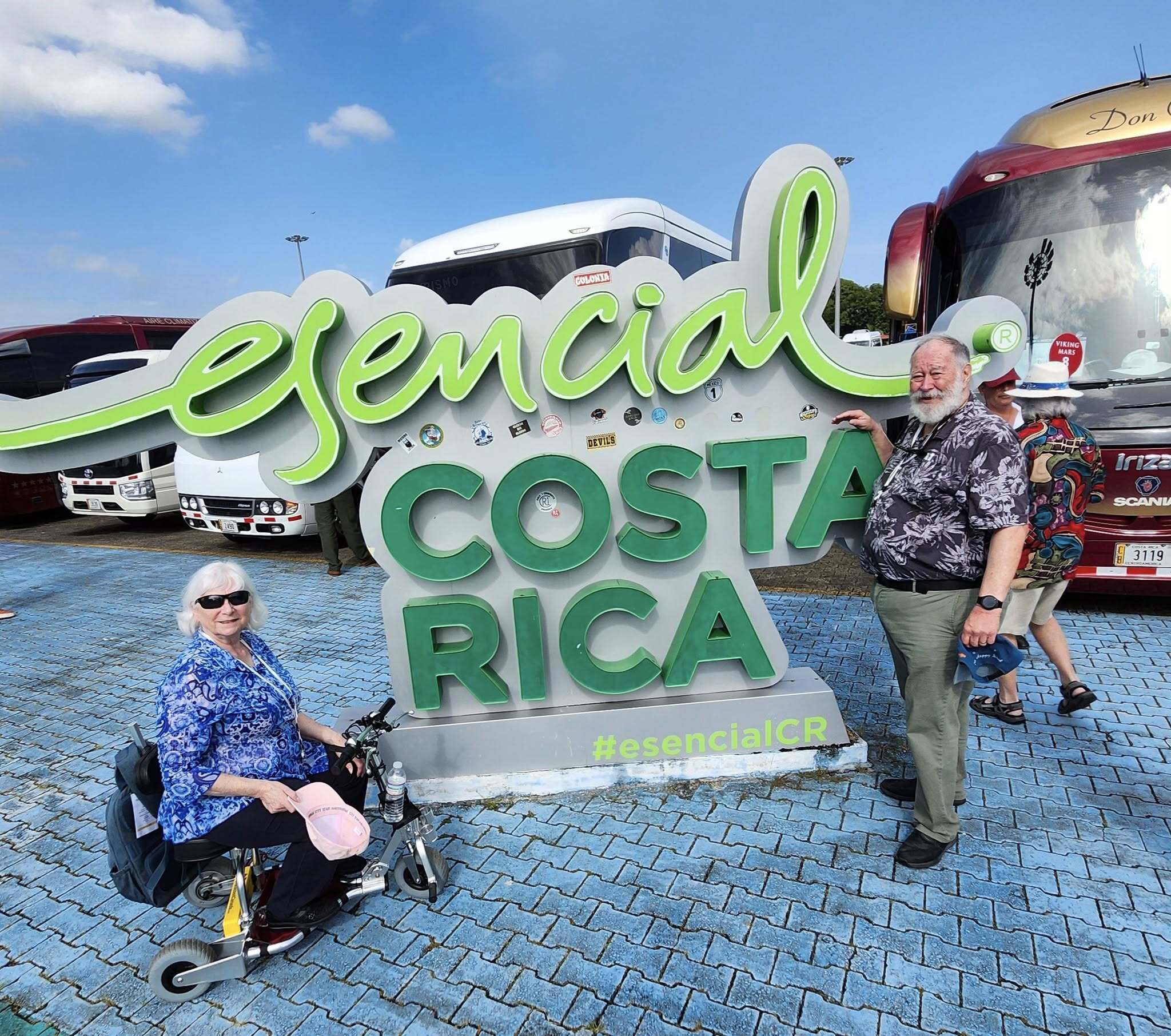 Woman on travel scooter in front of Costa Rica sign