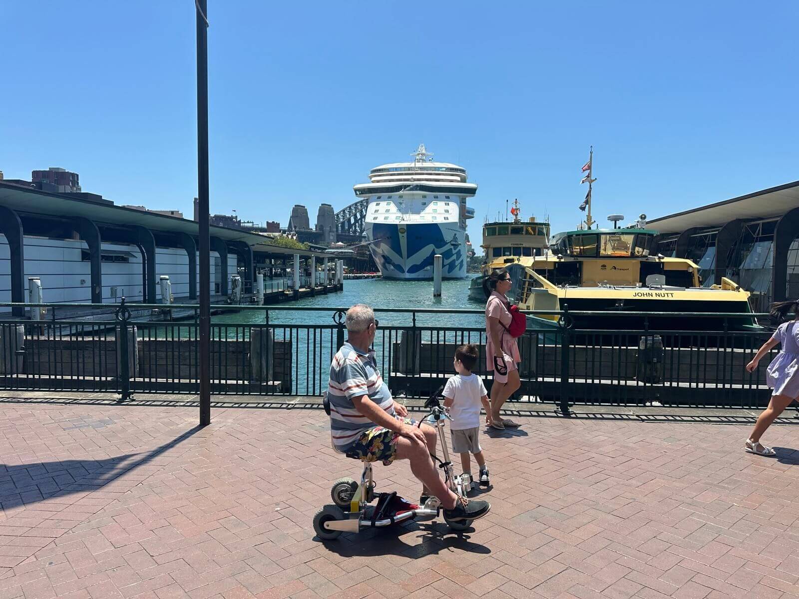 Mobility scooter cruisers in front of their cruise ship.