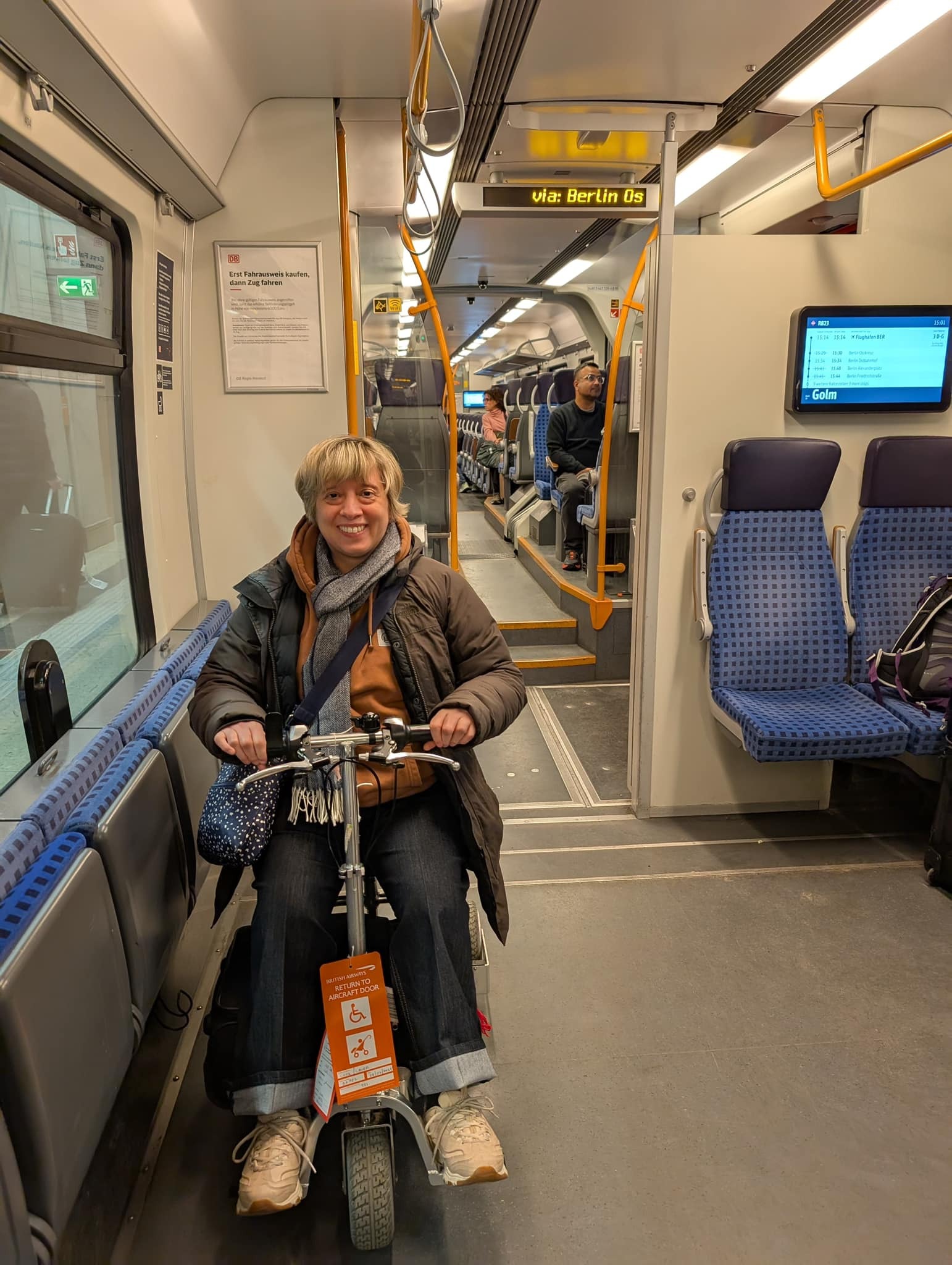 woman riding travel scooter on train