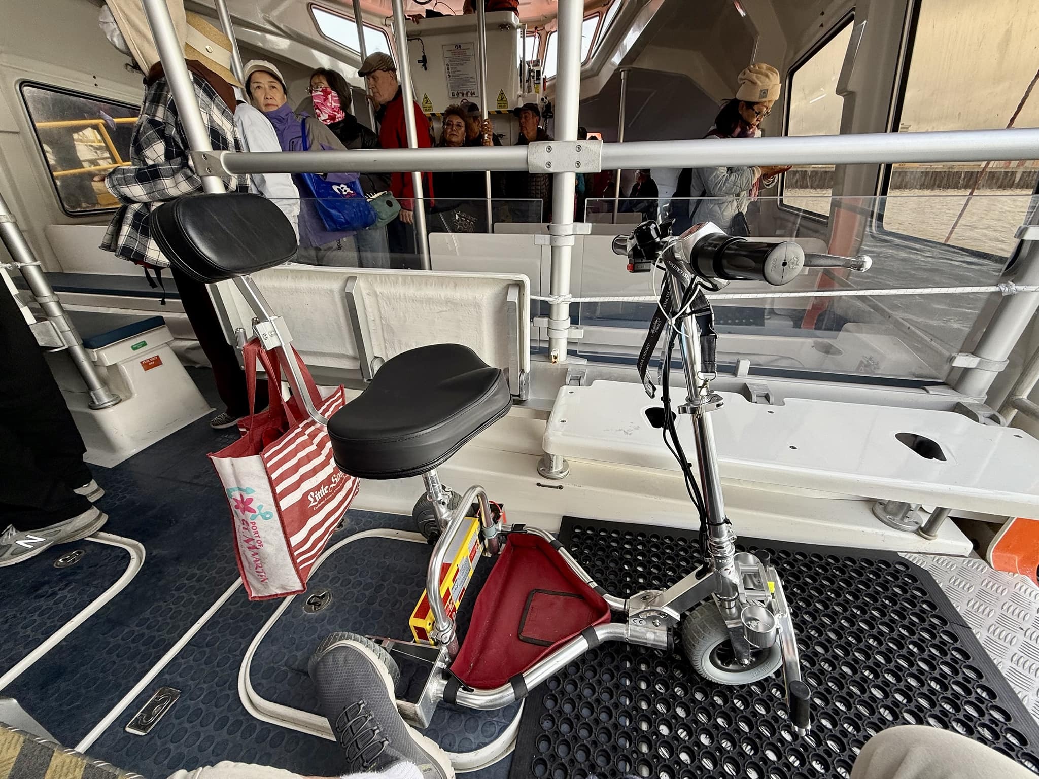 A travel scooter on a cruise tender unattended.