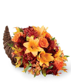 This unique cornucopia is overflowing with bright lilies, fall daisies, and orange roses. It is a perfect way to celebrate thankfulness this season!