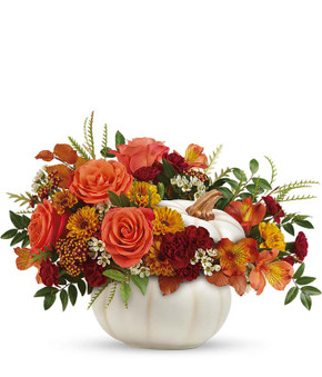 This makes a great piece for your own home or as a gift to someone you love. A charming white pumpkin holding orange roses and Peruvian lilies, yellow mums, maroon mini carnations, white wax flower and brilliant greens will bring a smile to your face!
This makes a great piece for your own home or as a gift to someone you love. A charming white pumpkin holding orange roses and Peruvian lilies, yellow mums, maroon mini carnations, white wax flower and brilliant greens will bring a smile to your face!