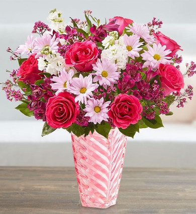 In this keepsake spiral pink vase there are a mix of pink roses, shades of purple alstroemeria and wax flower, along with daisies and sweet-smelling stock.  This bouquet is a sure way to say, "You got the Best of My Love."