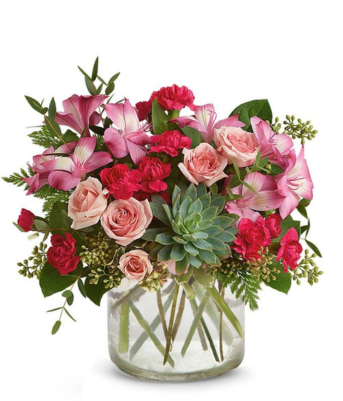 This meaningful bouquet has tones of pink spray roses, mini carnations, and alstroemeria with various green eucalyptus and a silk succulent all in a cylinder clear vase.  It's a great way to show your loved one that they are always on your mind.