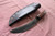 Large hand forged skinning knife with curly maple handle and riveted sheath