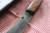 Large hand forged skinning knife with curly maple handle and riveted sheath