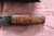 Large hand forged skinning knife with curly maple handle and riveted sheath