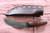 Hand forged skinning knife with curly maple handle and riveted sheath