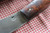 Hand forged skinning knife with curly maple handle and riveted sheath