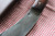 Hand forged skinning knife with curly maple handle and riveted sheath