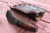 Hand forged skinning knife with curly maple handle and riveted sheath