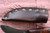 Hand forged skinning knife with curly maple handle and riveted sheath