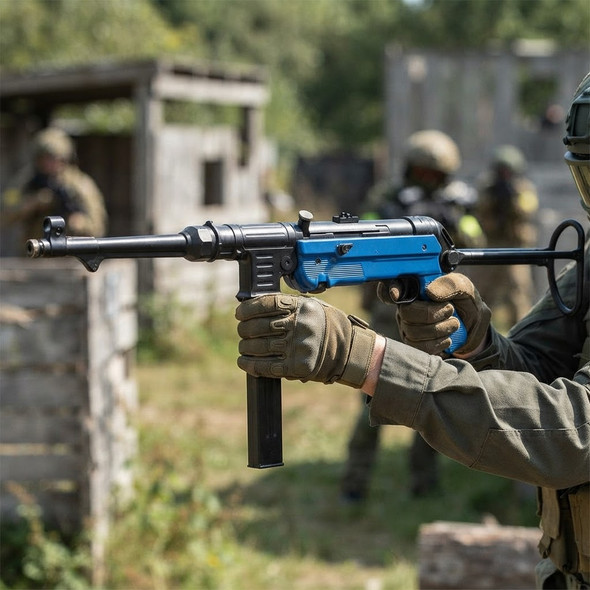 AGM MP40 AEG Airsoft Rifle in Two‑Tone Blue held horizontally during an outdoor airsoft game