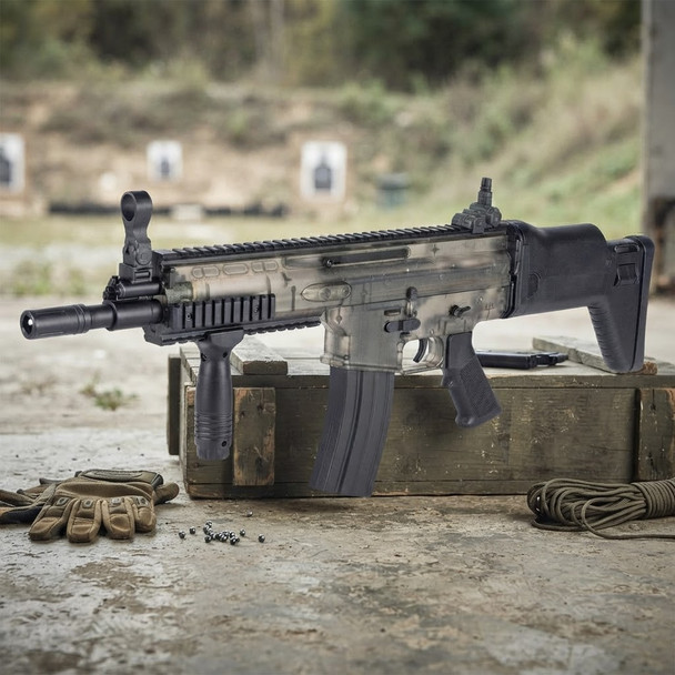Blackviper SCAR Tactical Spring Airsoft Rifle in Clear displayed on a crate at an outdoor range
