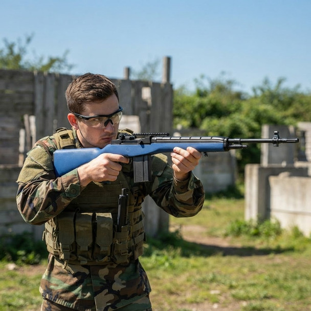 Player in camo aiming the AGM MP008A - M14 AEG Airsoft Rifle AEG in Blue at an outdoor skirmish field