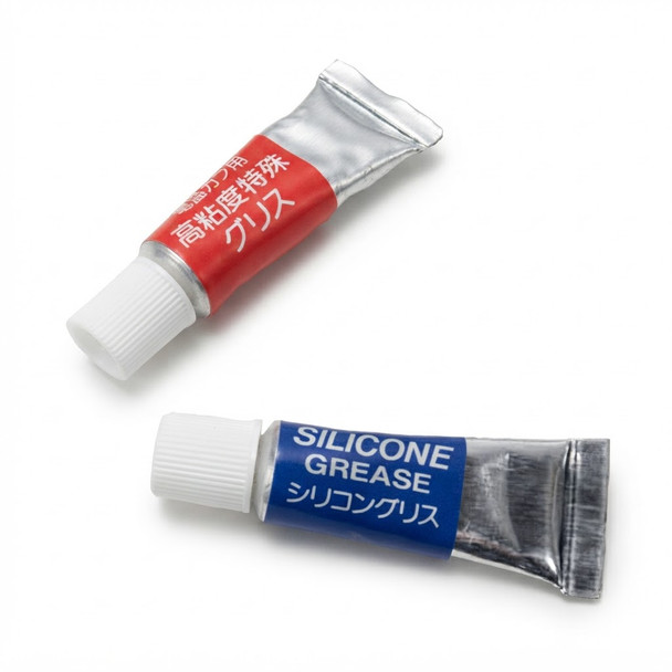 Top-down view of the Tokyo Marui Gear and Cylinder Grease Set featuring red and blue tubes on a white background.